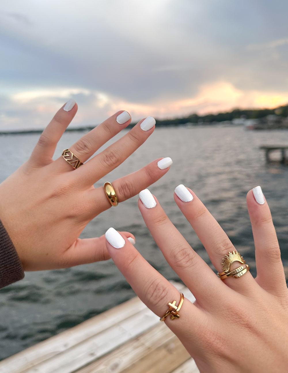 Gold statement rings with geometric fronts on fingers
