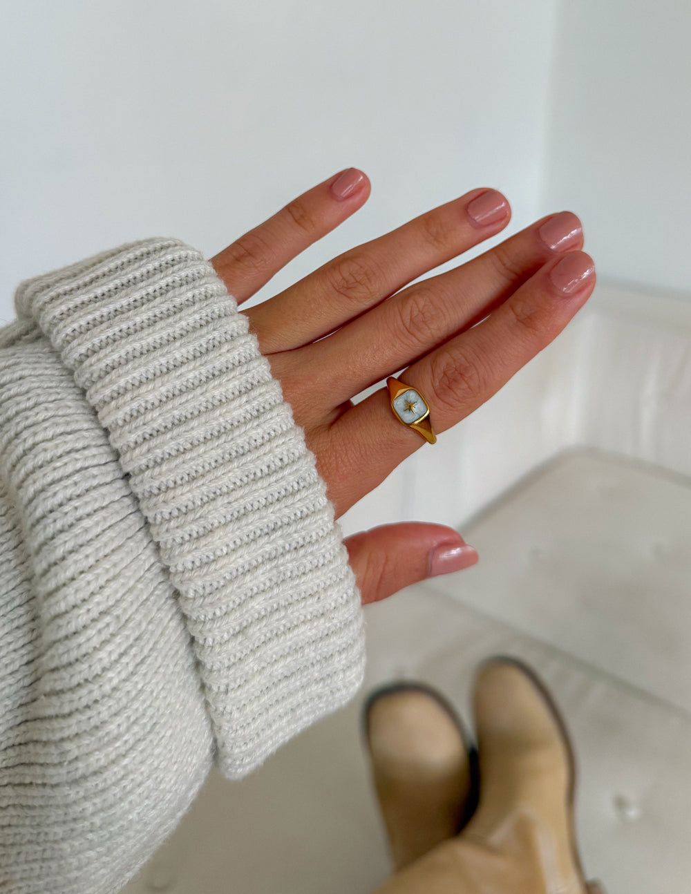Gold-tone enamel star ring with light blue square face, worn on hand