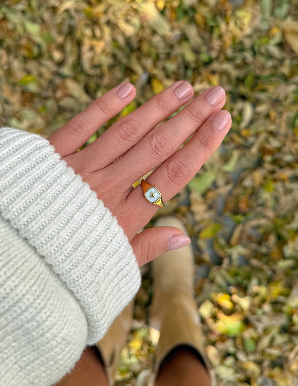 Gold-tone enamel star ring with light blue square setting on finger