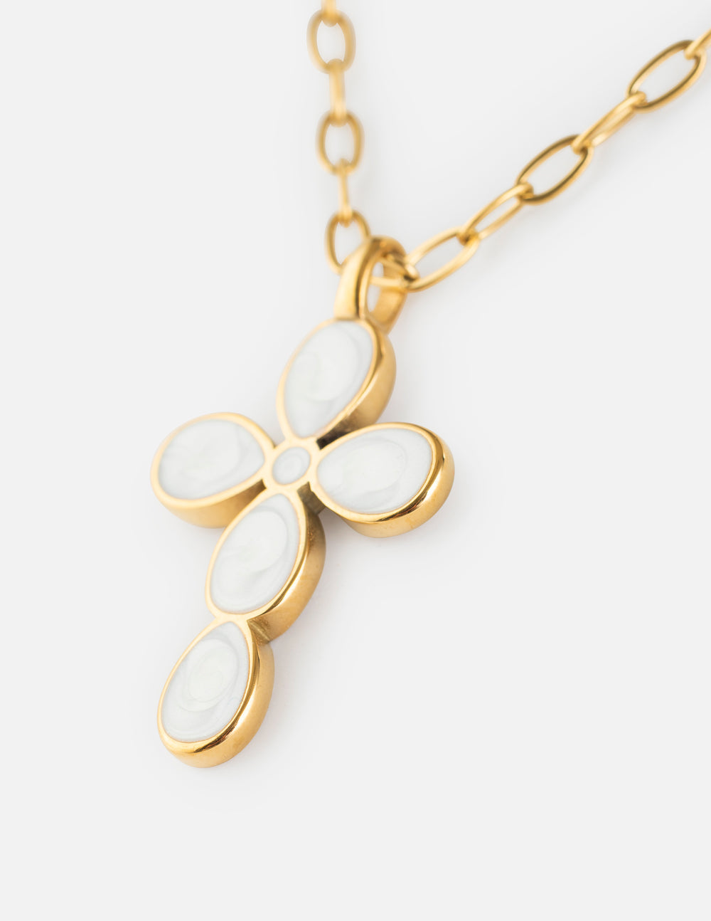 Gold paperclip chain necklace with oval teardrop cross pendant close-up