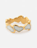 Gold heart-detail ring with three linked heart stones and enamel accents