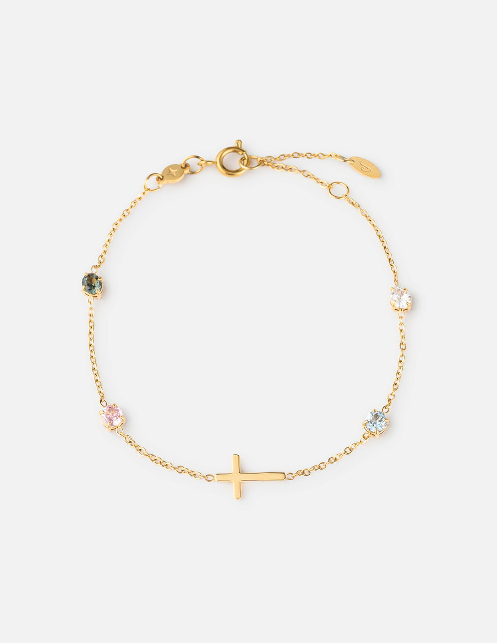 Gold link bracelet with small multicolor stones and a gold cross charm