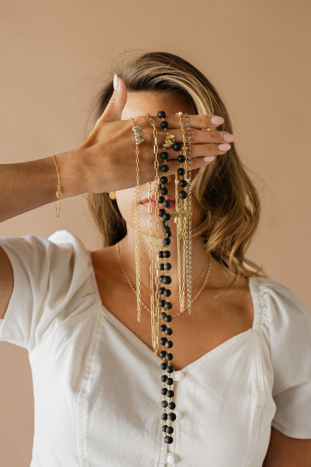 Long gold-tone necklace featuring long black bead fringe and multiple dangling strands