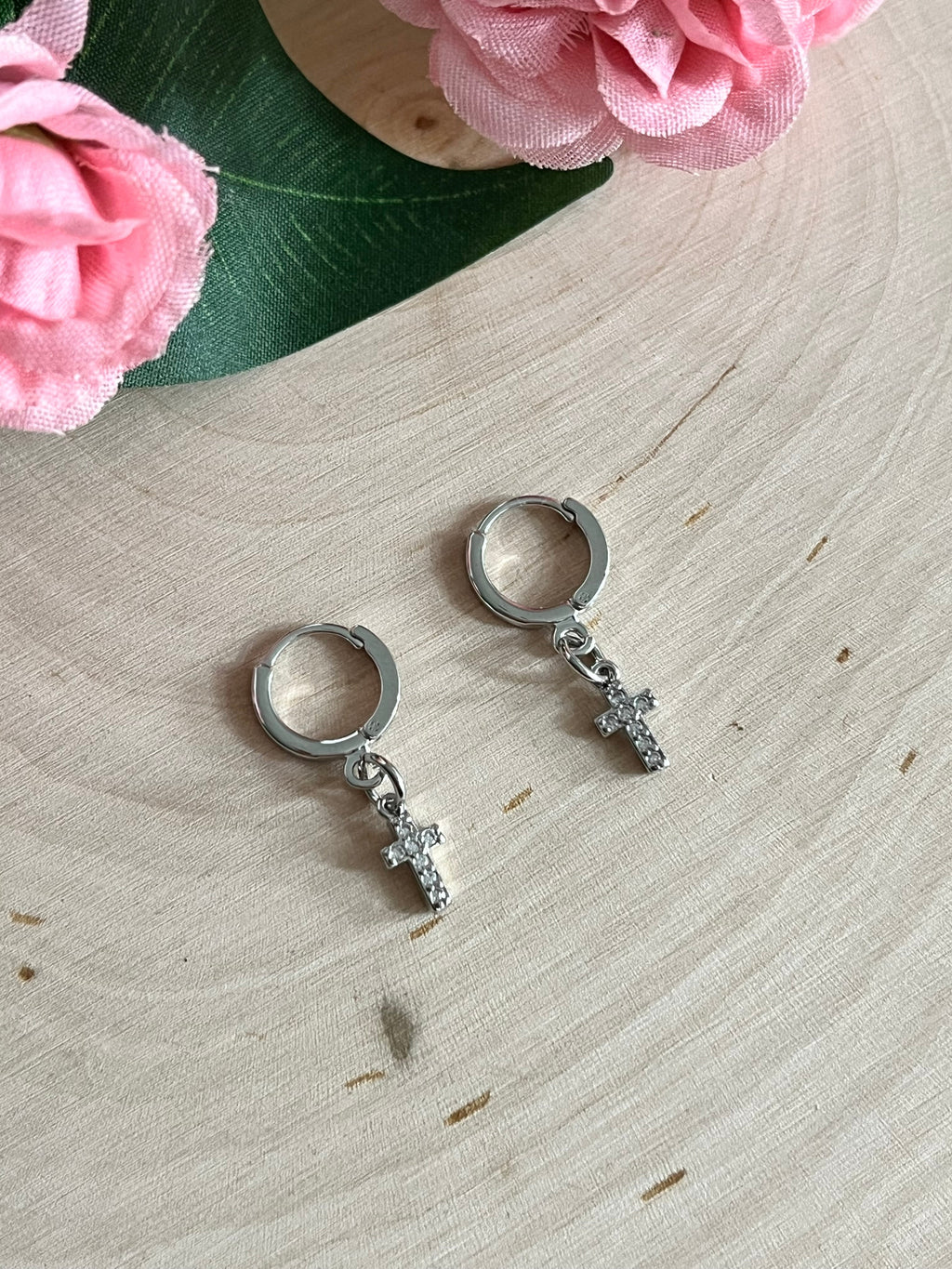 Silver huggie hoop earrings with cross charms, pair viewed from the front