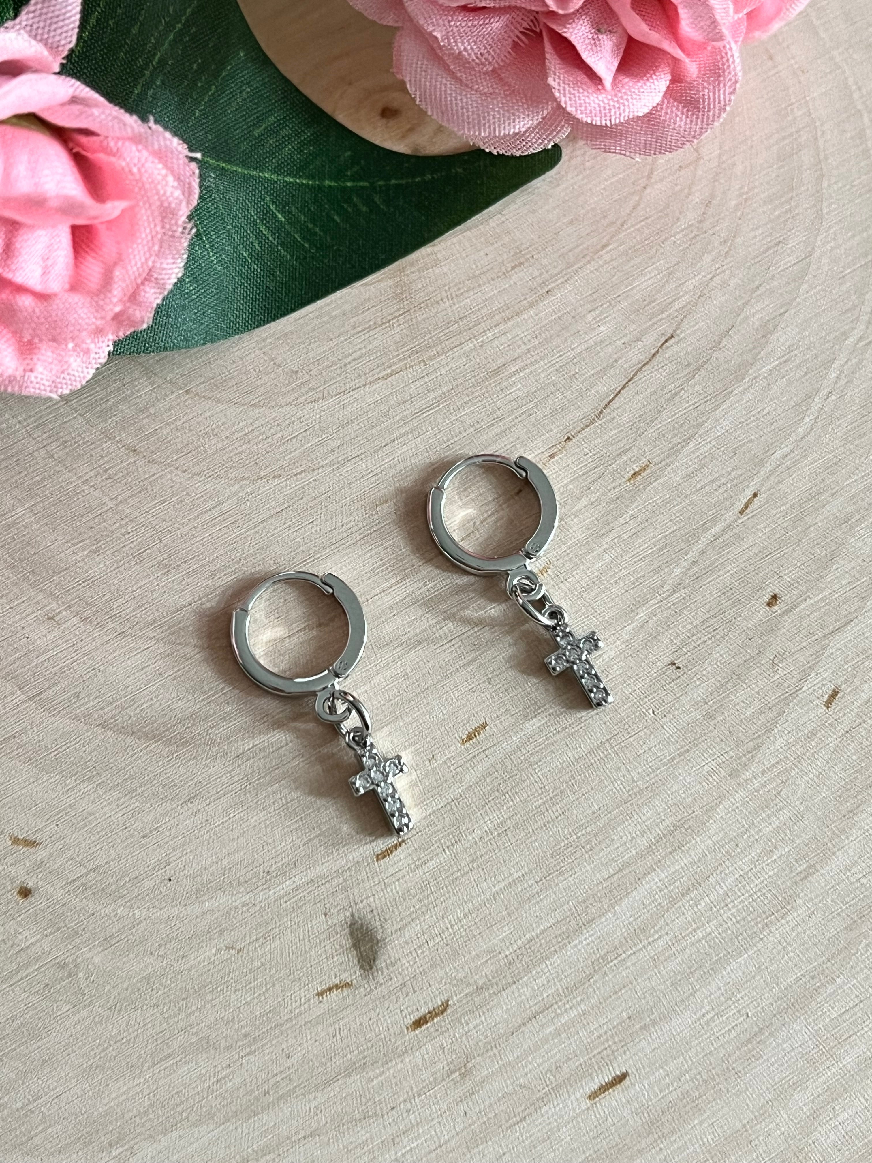 Silver huggie hoop earrings with cross charms, pair viewed from the front