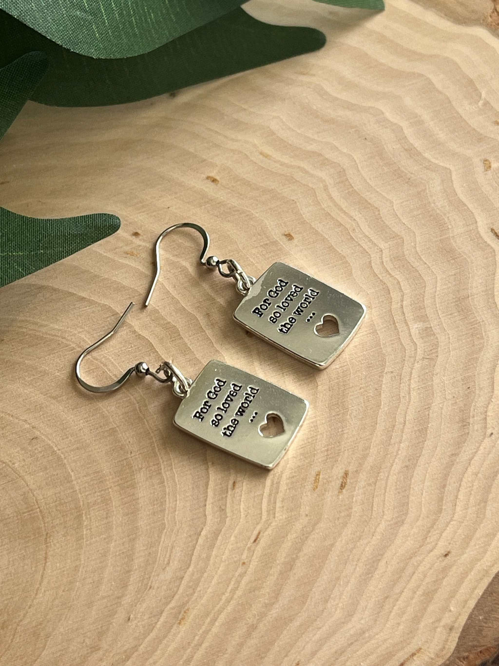Silver dangle earrings with square engraved tags, heart cutout, and fishhook backs