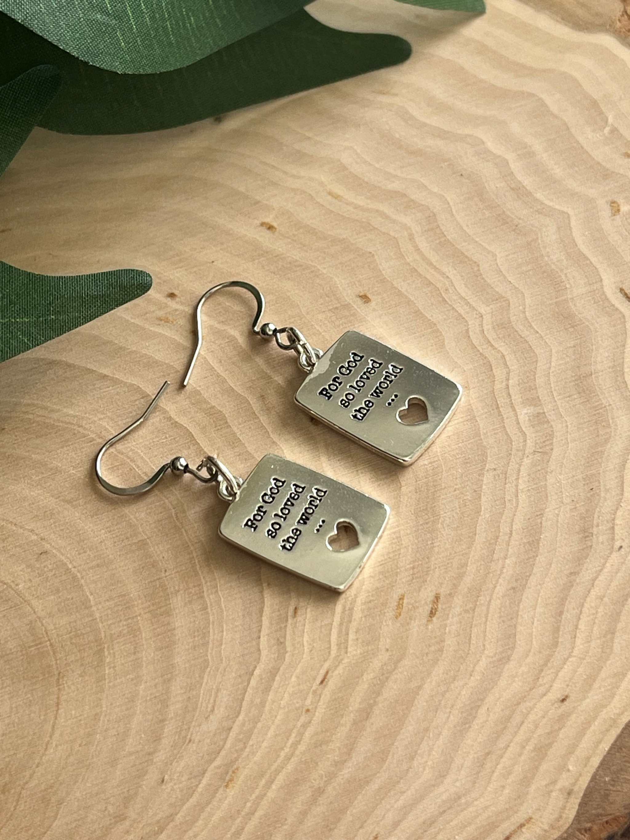 Silver dangle earrings with square engraved tags, heart cutout, and fishhook backs