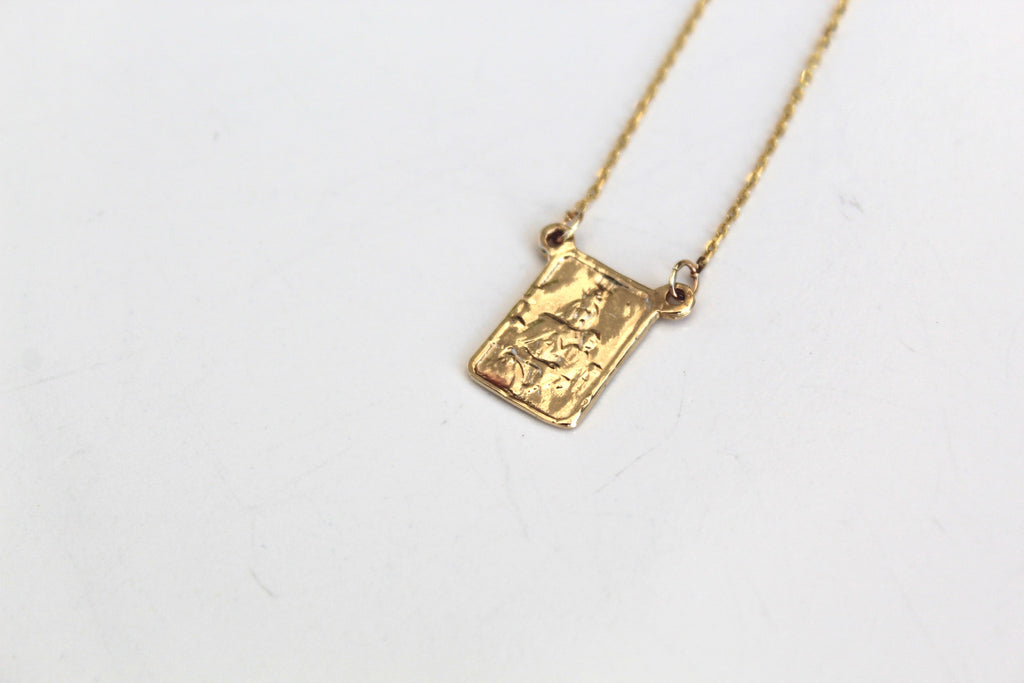 Gold square scapular pendant with detailed front engraving on a chain