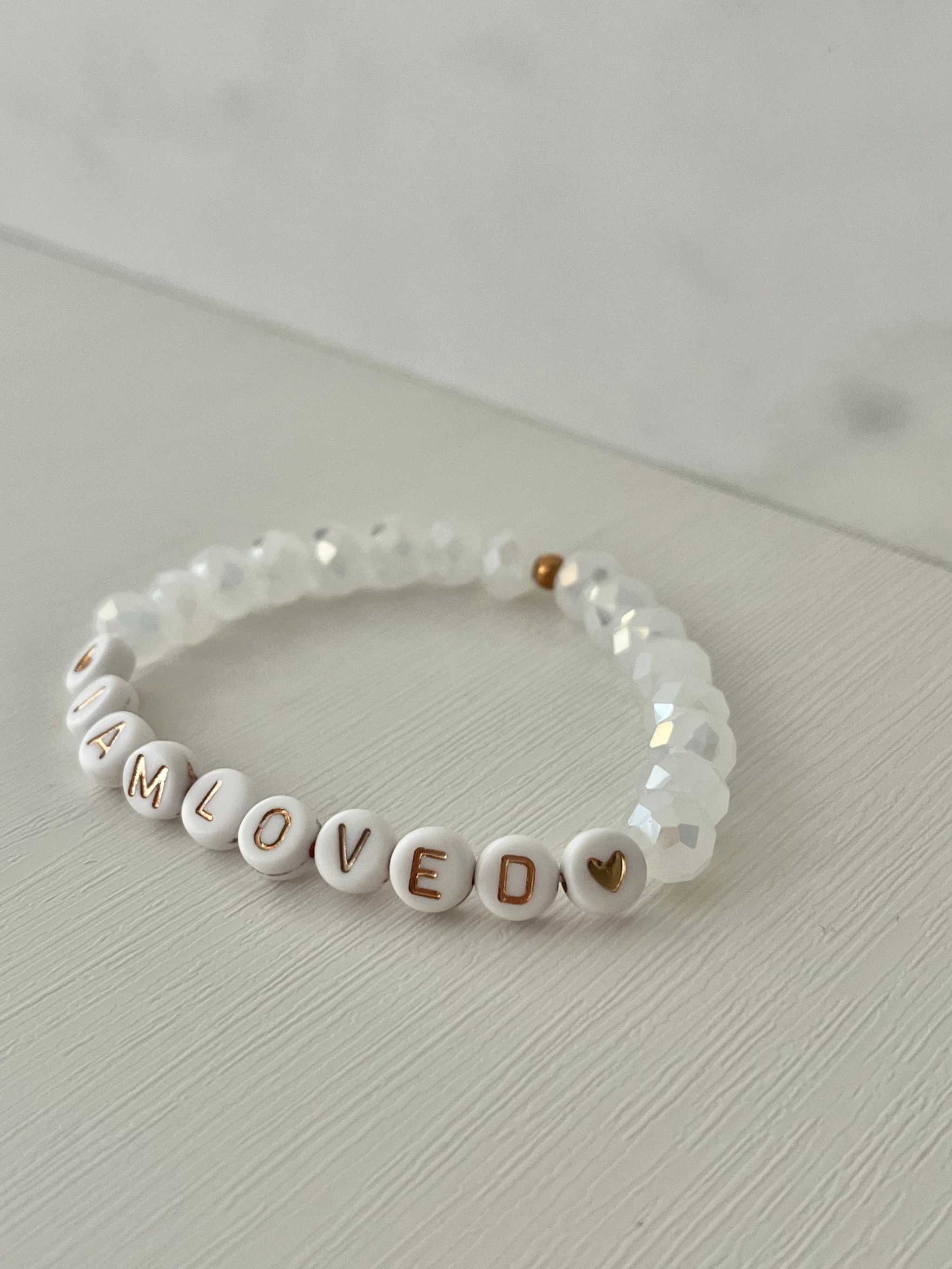 White beaded bracelet with faceted crystal beads and 'I AM LOVED' letter beads
