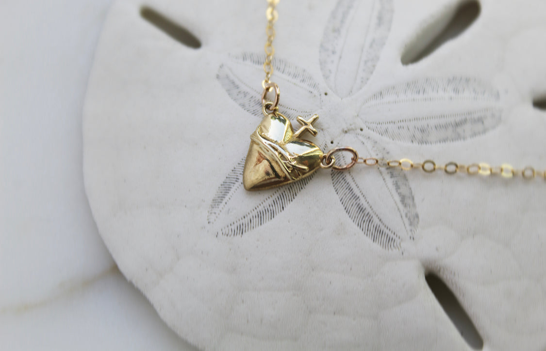 Gold-tone heart pendant necklace with cross on thin chain