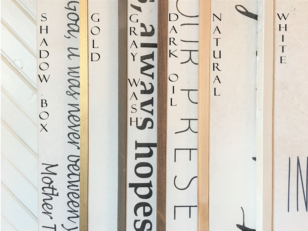 Close-up of vertical wooden sign panels with printed letter styles