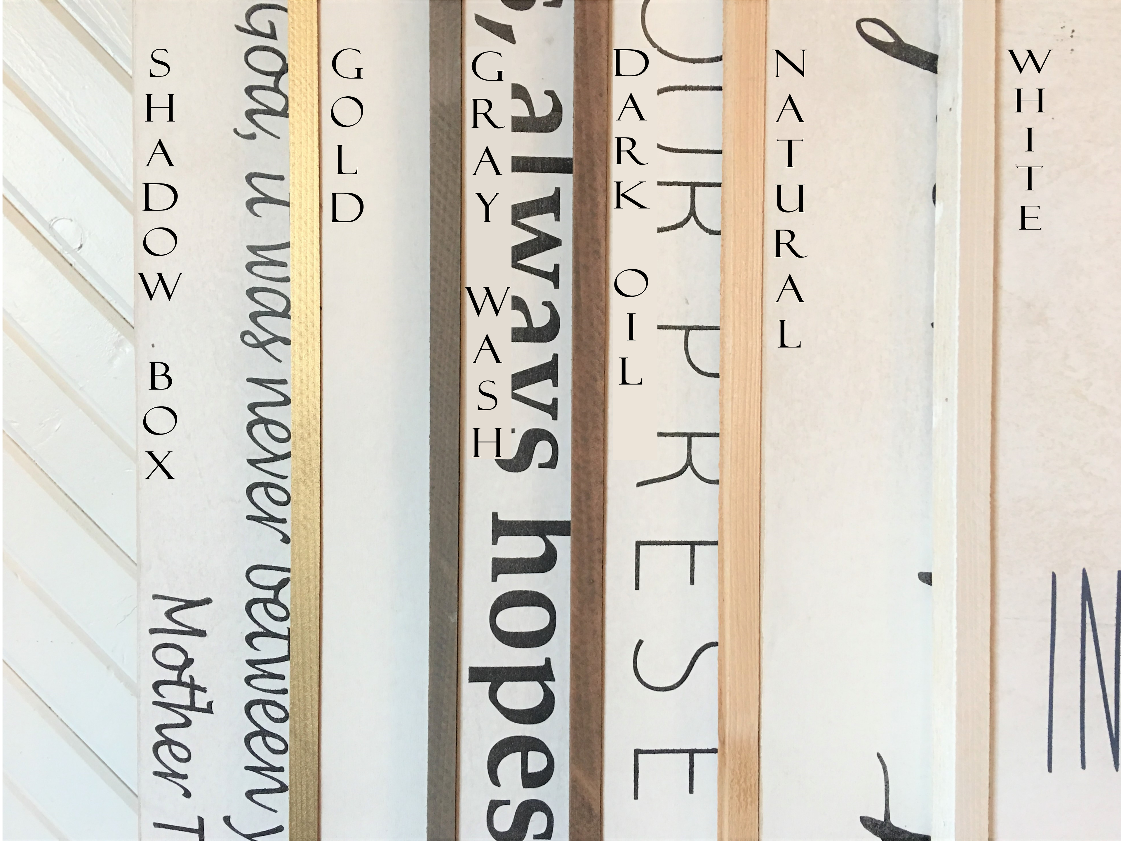 Close-up of vertical wooden sign panels with printed letter styles