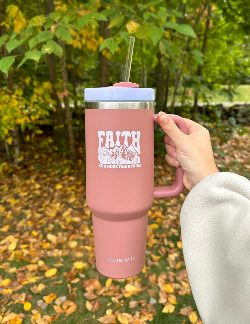 40 oz insulated tumbler in rose pink, side view with “FAITH” text and straw