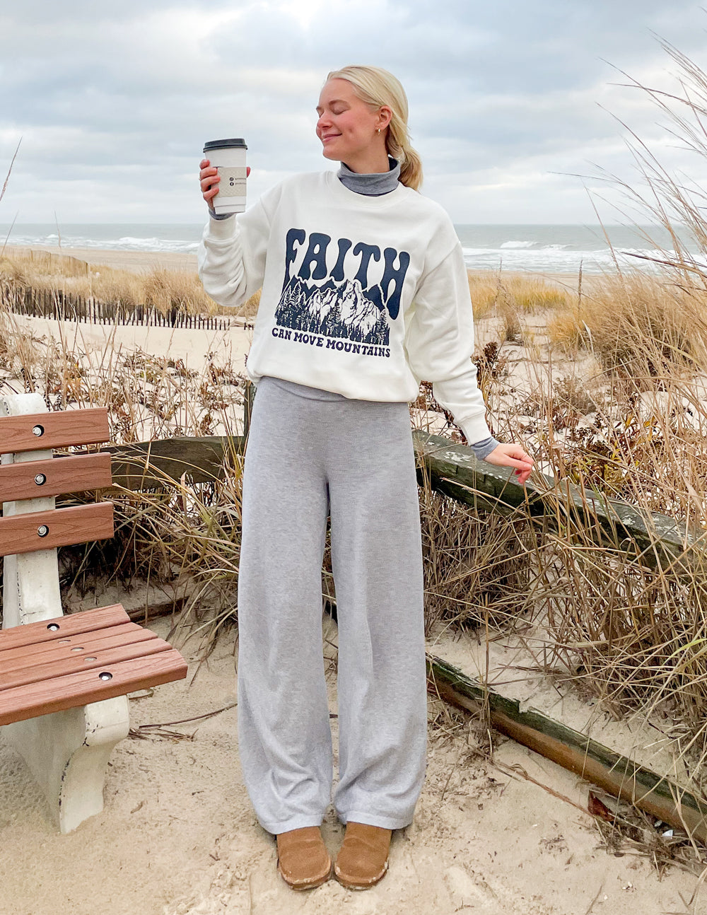 White crewneck sweatshirt with “Faith” mountain graphic, ribbed collar and cuffs