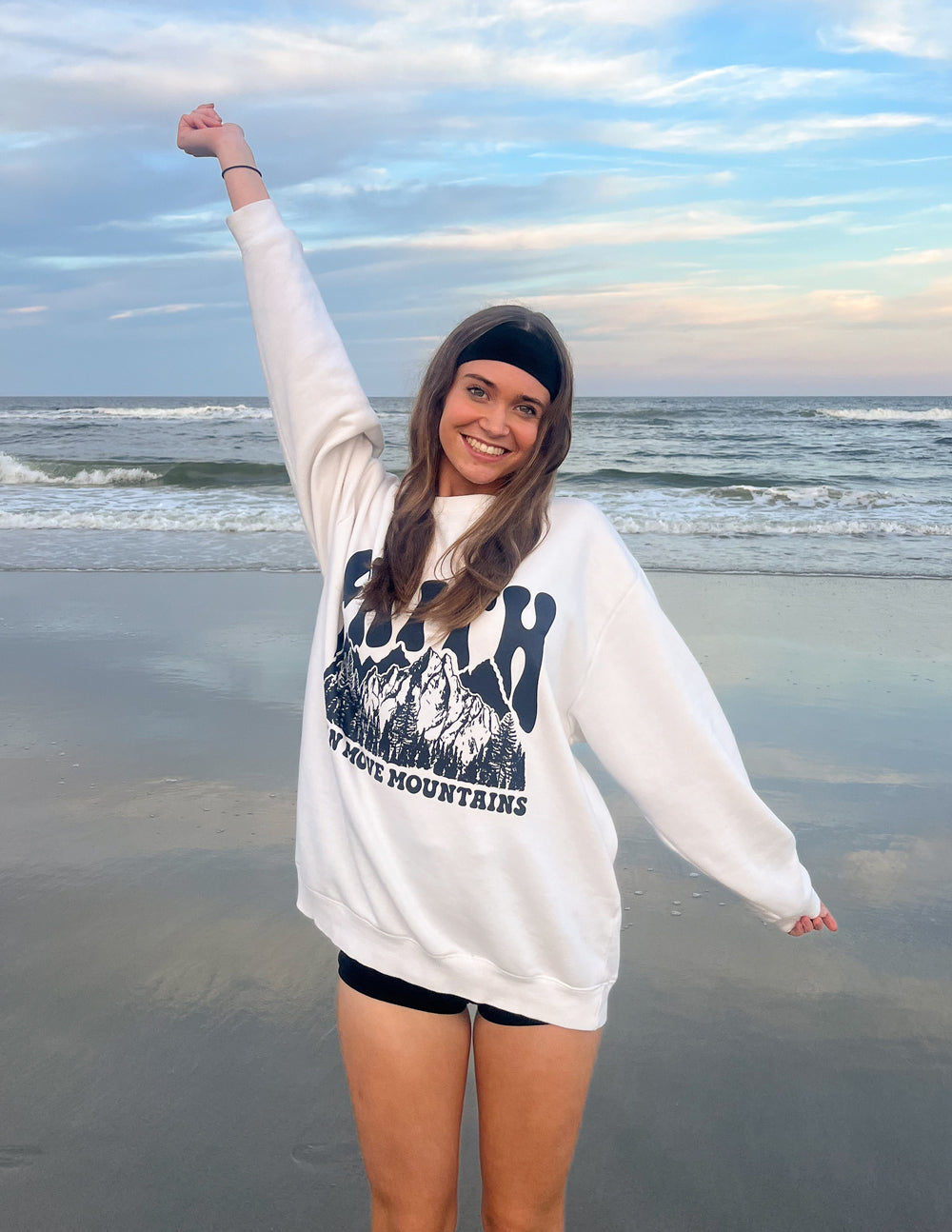 White relaxed-fit crewneck sweatshirt with dark “Faith” mountain graphic on chest