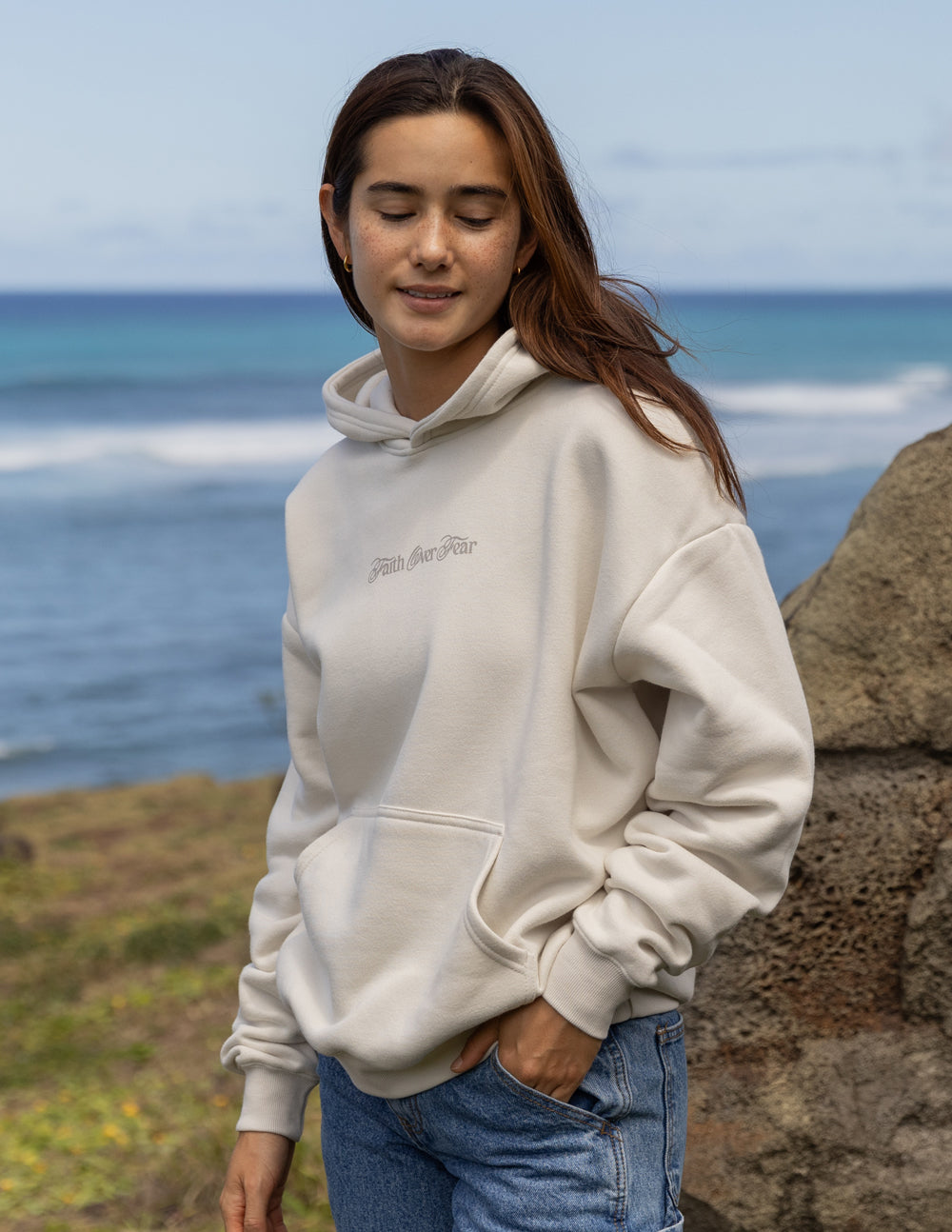 Light hoodie with hood, kangaroo pocket, and 'Faith over Fear' chest print