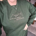 Dark green crewneck sweatshirt with embroidered faith and mountain verse on chest