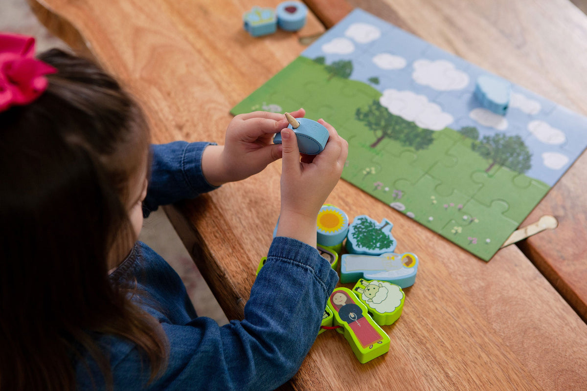 Children's lacing puzzle set on tabletop with wooden/foam-style pieces and parts