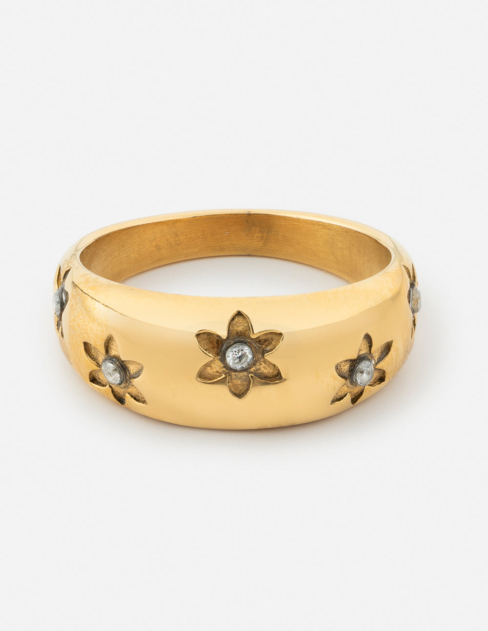 Gold-tone dome ring with five engraved flowers and small dark stone accents
