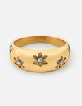 Gold-tone dome ring with five engraved flowers and small dark stone accents