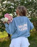 Light blue unisex crewneck sweatshirt, back “Follow Jesus” graphic with hearts