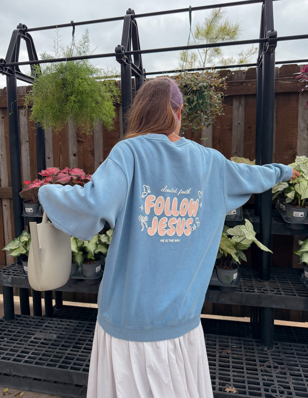 Light blue unisex crewneck sweatshirt, large back “Follow Jesus” print with stars
