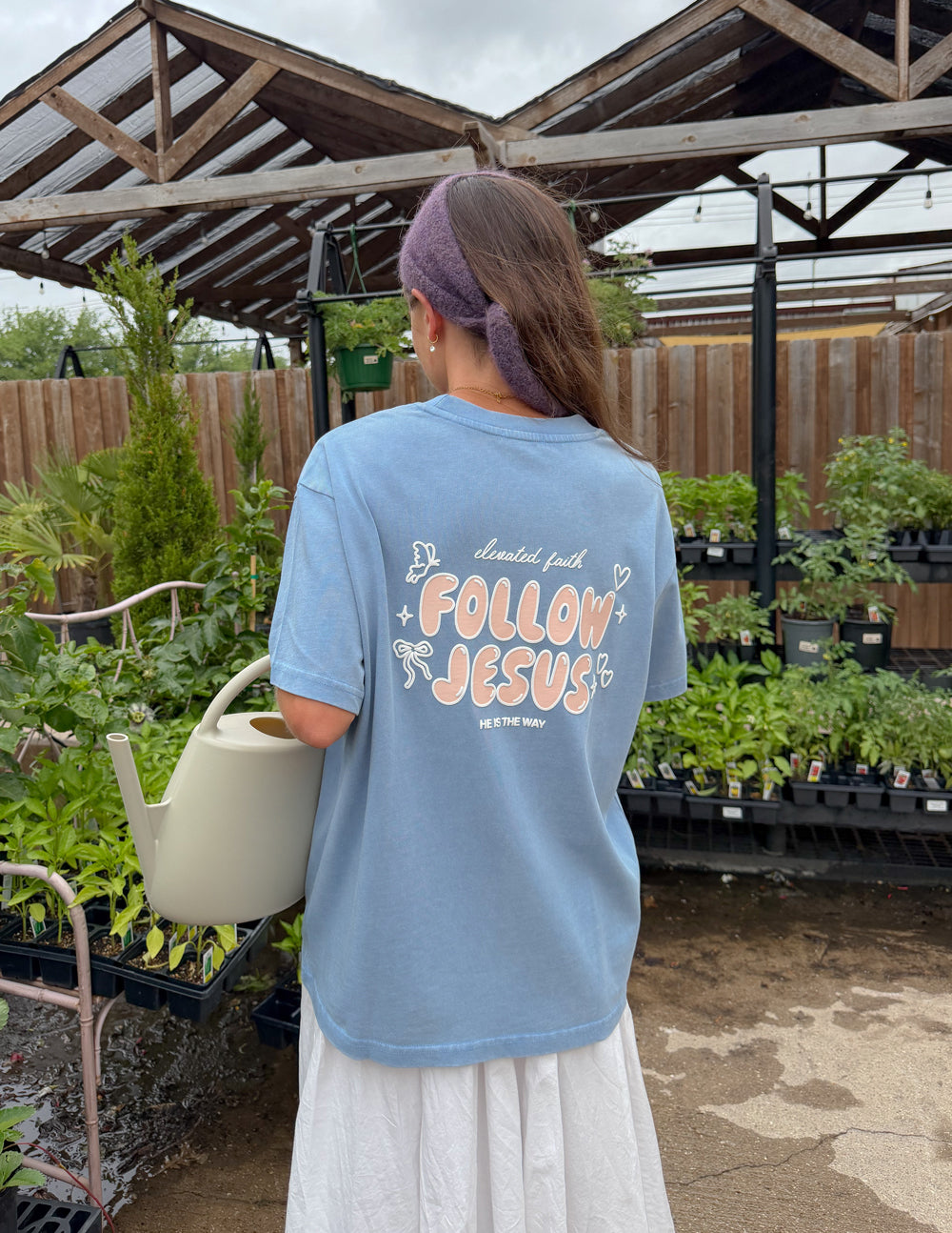 Unisex light blue T-shirt back view with large "Follow Jesus" graphic