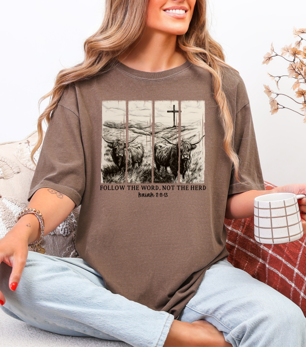Heather brown t-shirt with Highland cow graphic and 'FOLLOW THE WORD, NOT THE HERD' text