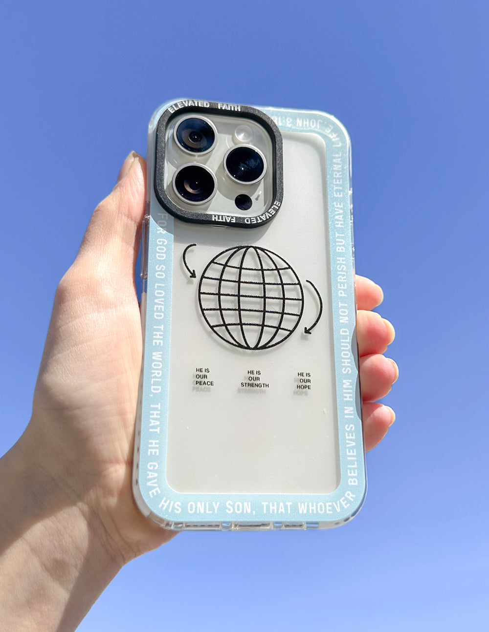 Light blue phone case held in hand, with black globe and curved text