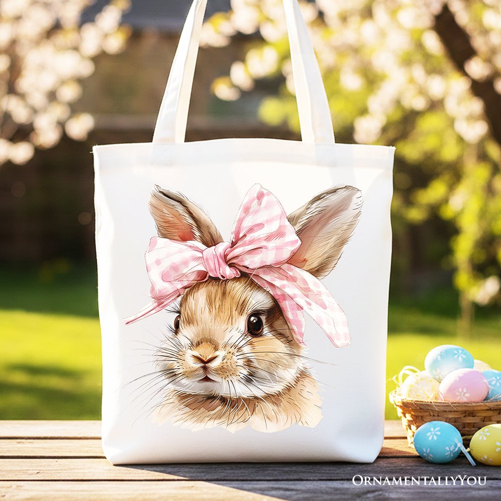 Beige tote bag with watercolor bunny face and pink bow on front