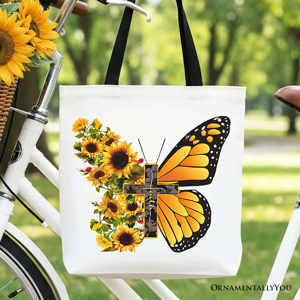White cotton tote bag with sunflower butterfly cross graphic, centered close-up