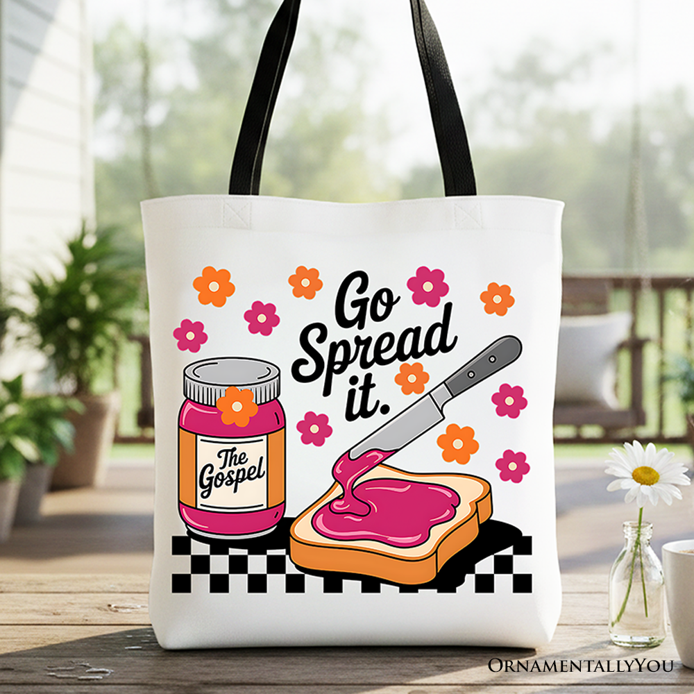 White canvas tote bag with black handles and colorful 'Go Spread It' print