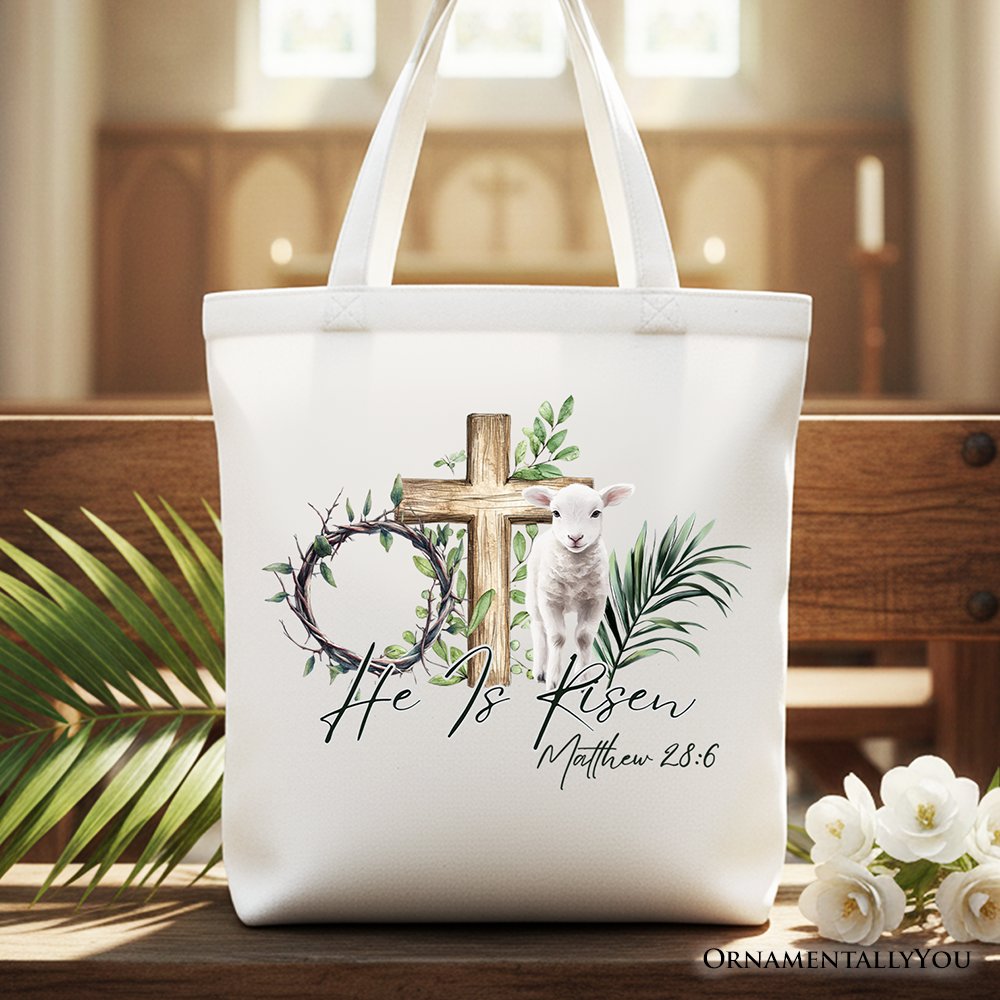 White Christian Easter tote bag with cross, lamb, and Matthew 28:6 verse print