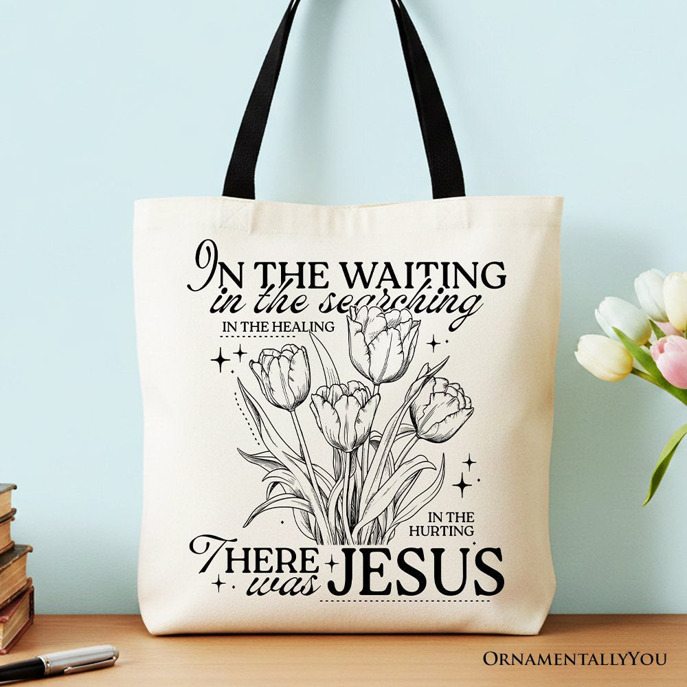Cream cotton tote bag with black handles, floral line-art scripture print, front view