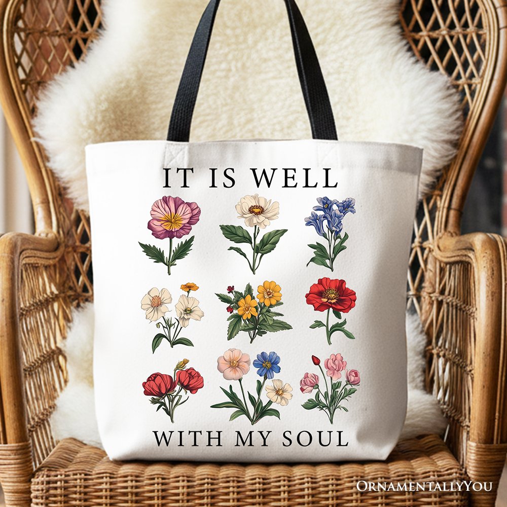White canvas tote with black handles, floral verse text 'IT IS WELL' and 'WITH MY SOUL'.