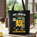 Black tote bag with 'My Jesus' lemonade graphic and yellow cartoon face.