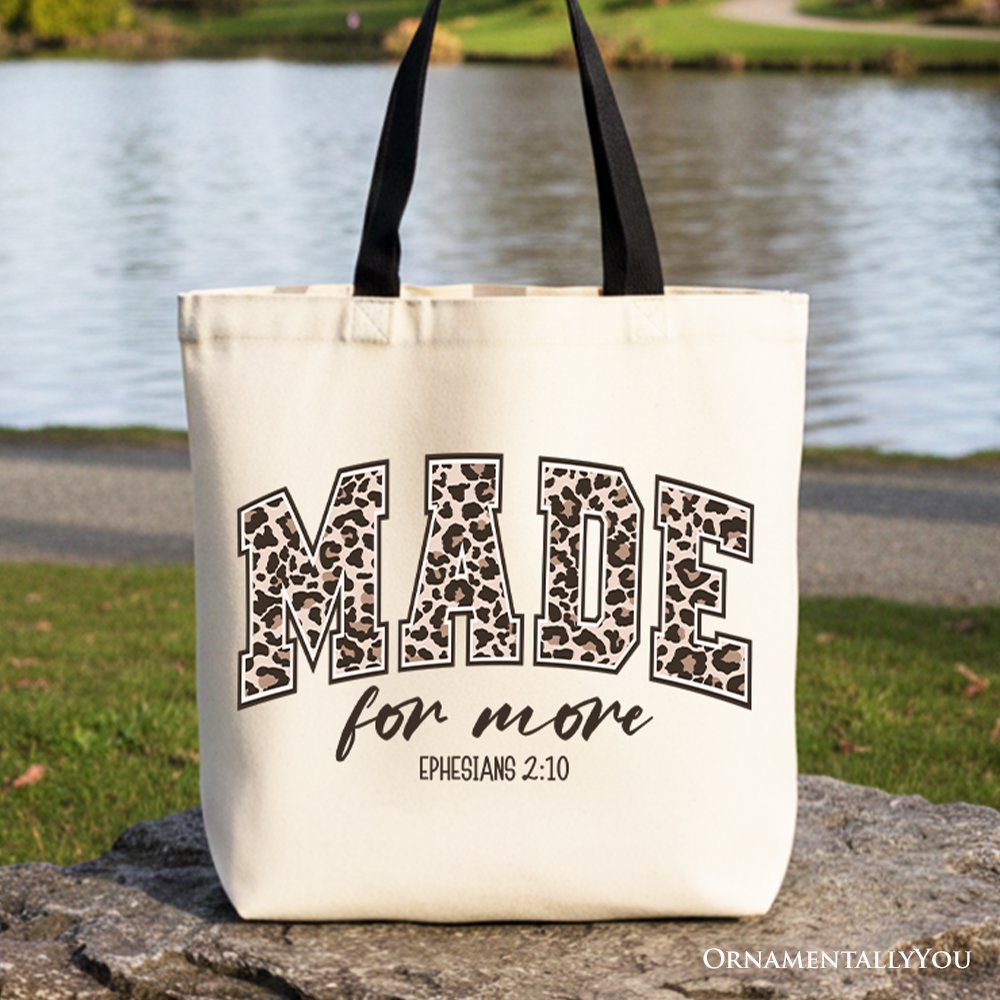 White canvas tote bag with black leopard-style "MADE for more" text and handles