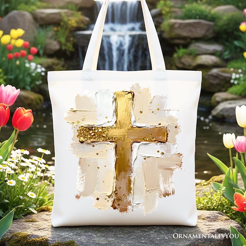 White canvas tote bag with large gold cross brushstroke print
