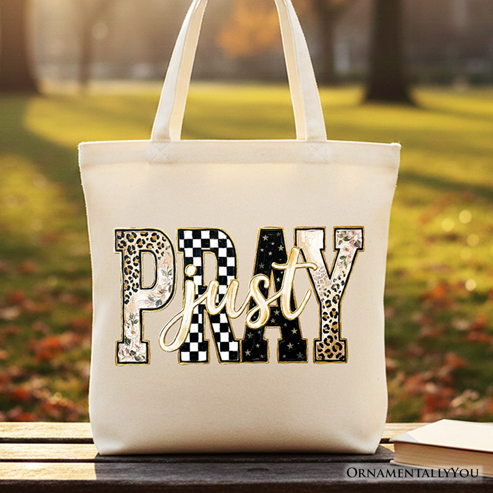 White tote bag with centered “Pray” patchwork graphic on the front