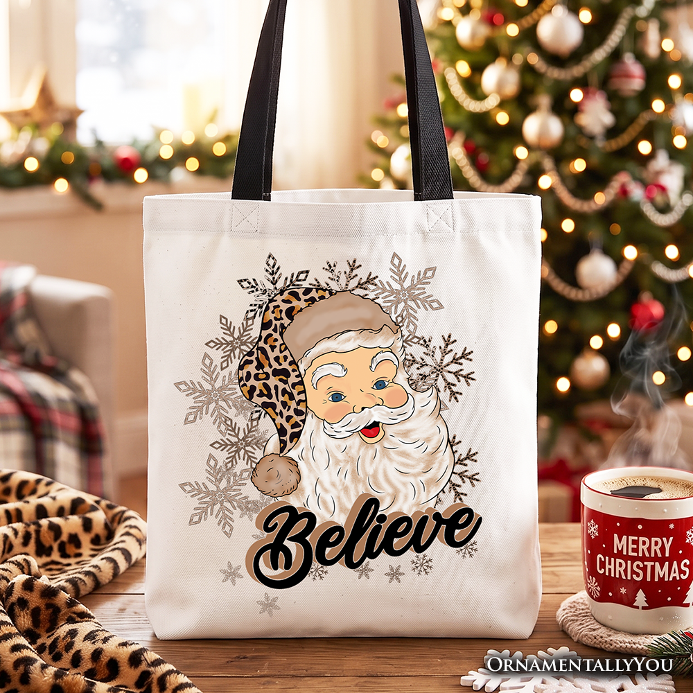 White cotton tote bag with Santa face, leopard print, and “Believe” front design