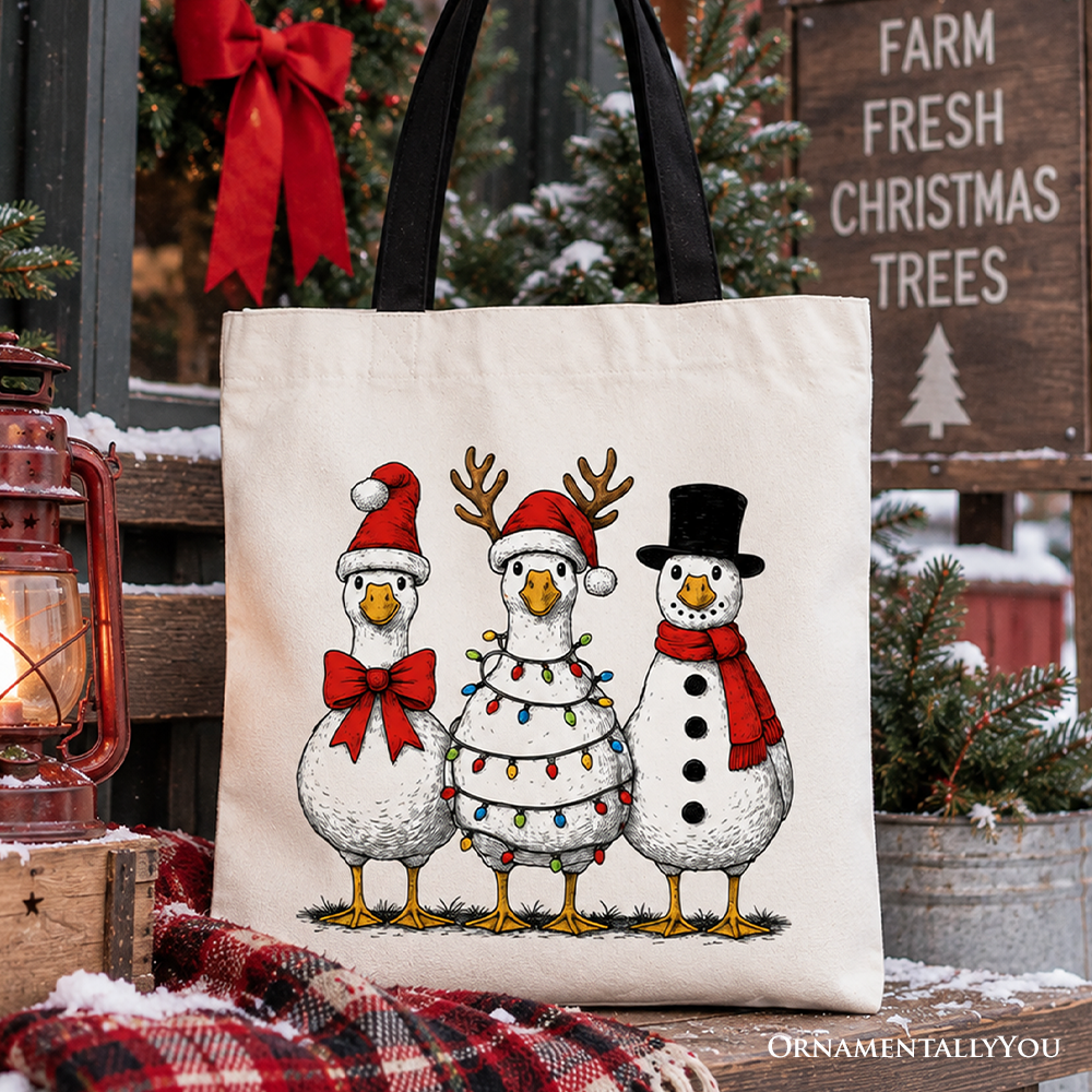 Christmas tote bag with three cartoon snowmen in red and black hats, black handles
