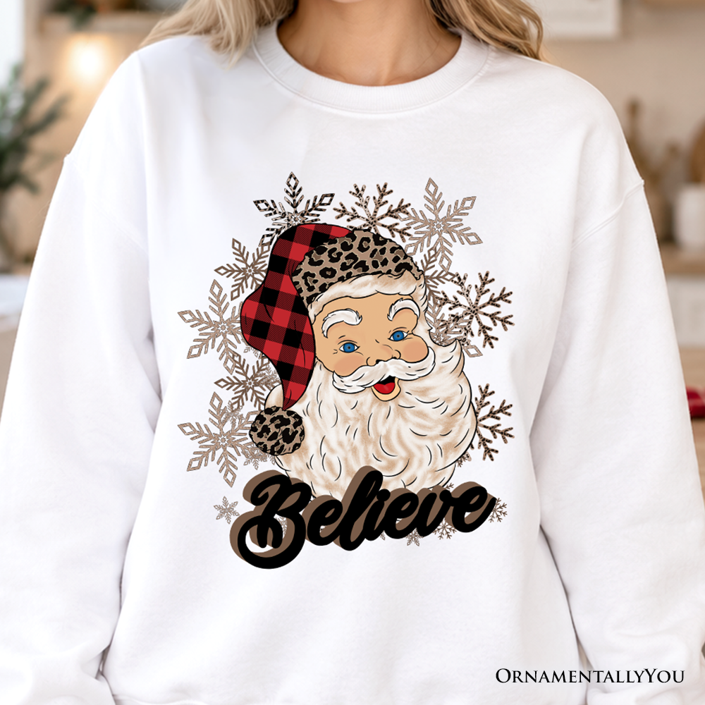 White crewneck sweatshirt with Santa face, snowflake graphic, and 'Believe' print