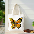 White tote bag with sunflower butterfly cross graphic, front view