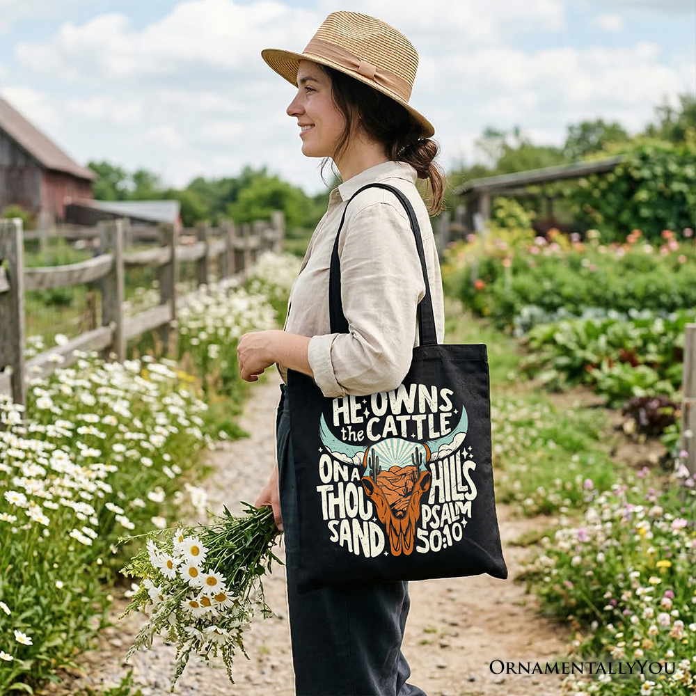 Black western tote bag with quote-and-bull graphic, carried as a shoulder bag