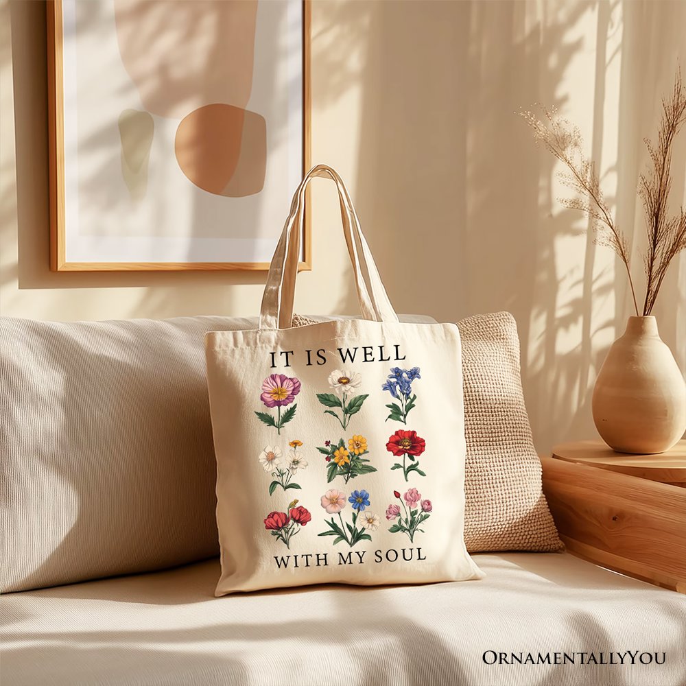 Cream canvas tote with long handles, floral 'IT IS WELL' and 'WITH MY SOUL' text.
