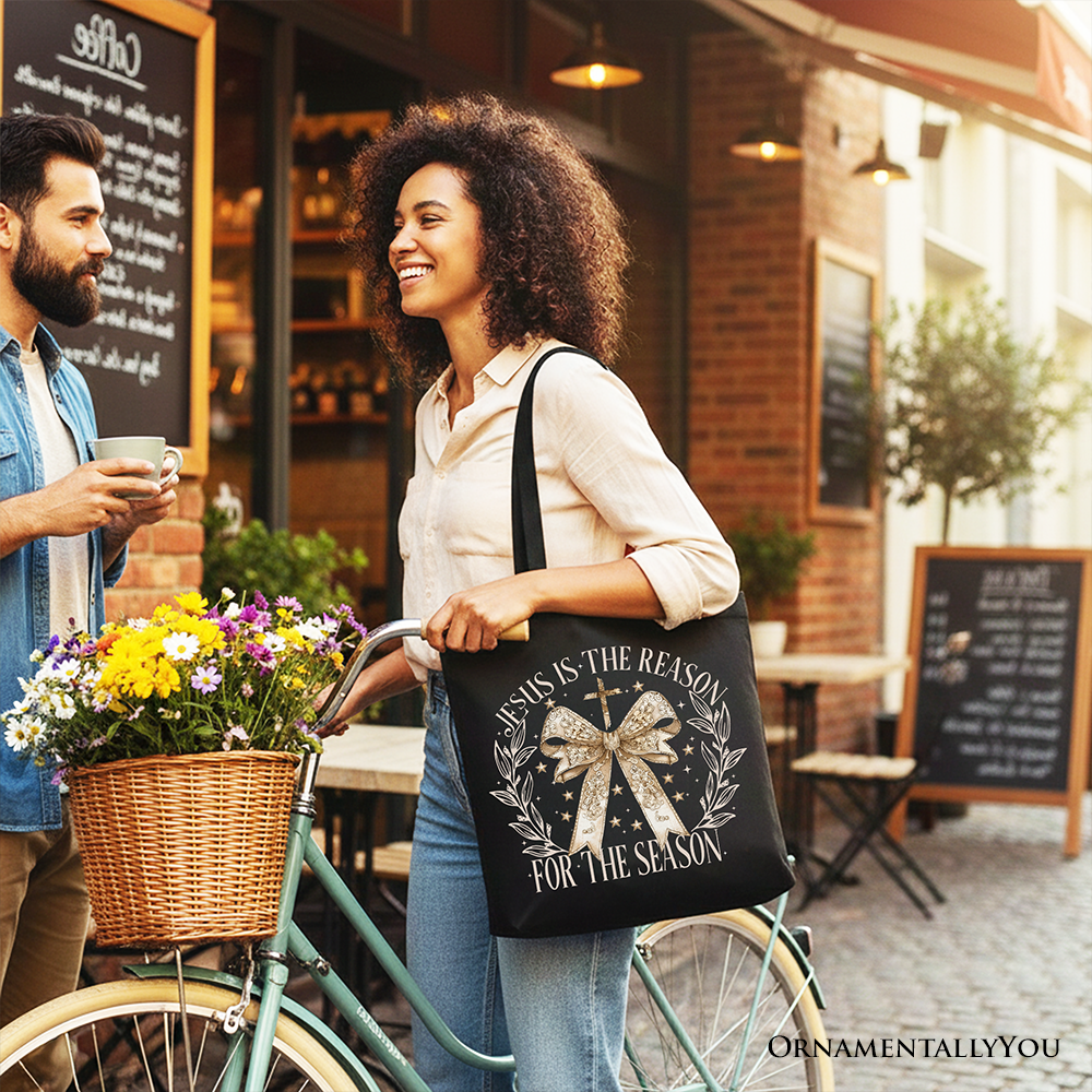Black Christmas tote bag with gold bow and “Jesus Is the Reason” front print