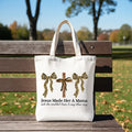 White tote bag with light handles, leopard bow and cross print on front panel.