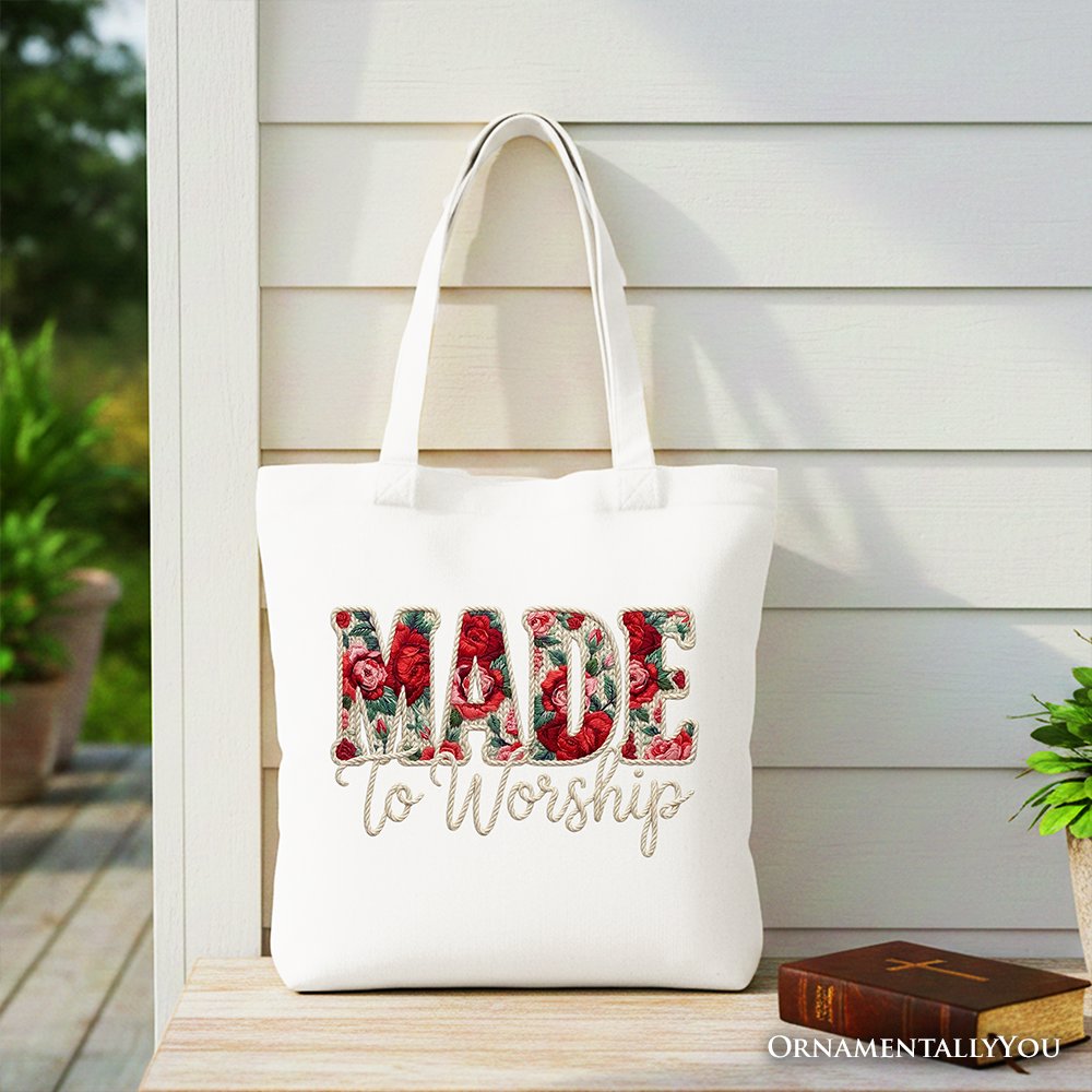 White tote bag with red handles and large floral “MADE to Worship” print