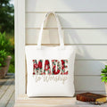 White tote bag with red handles and large floral “MADE to Worship” print