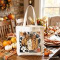 White canvas tote bag with orange pumpkin floral bow print and sturdy handles